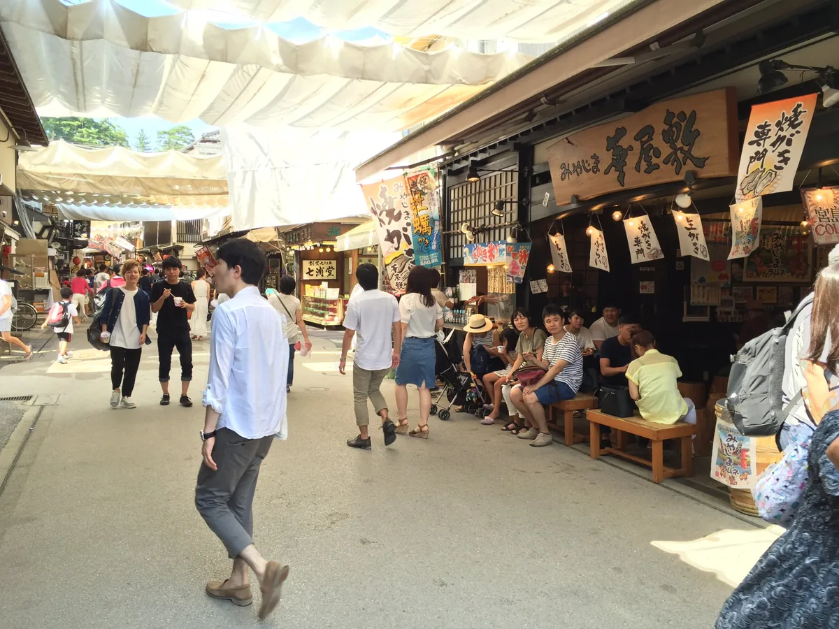 Miyajima's Omotesando shopping street shaded by white awnings