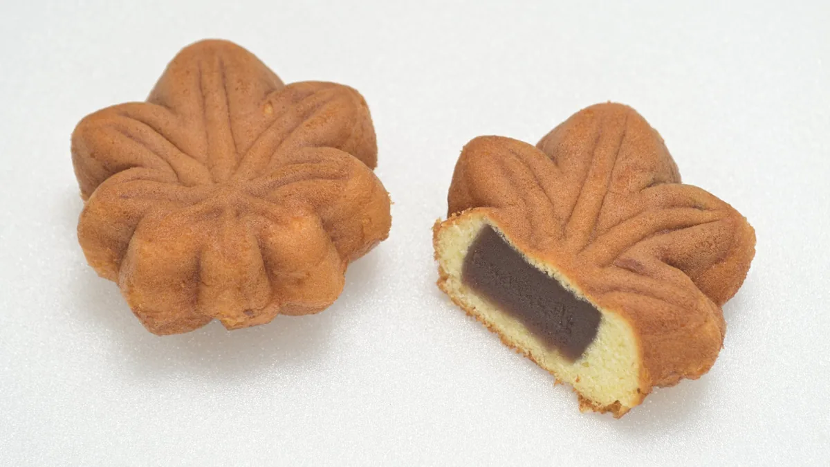 A momiji manju cut open to show the smooth red bean paste