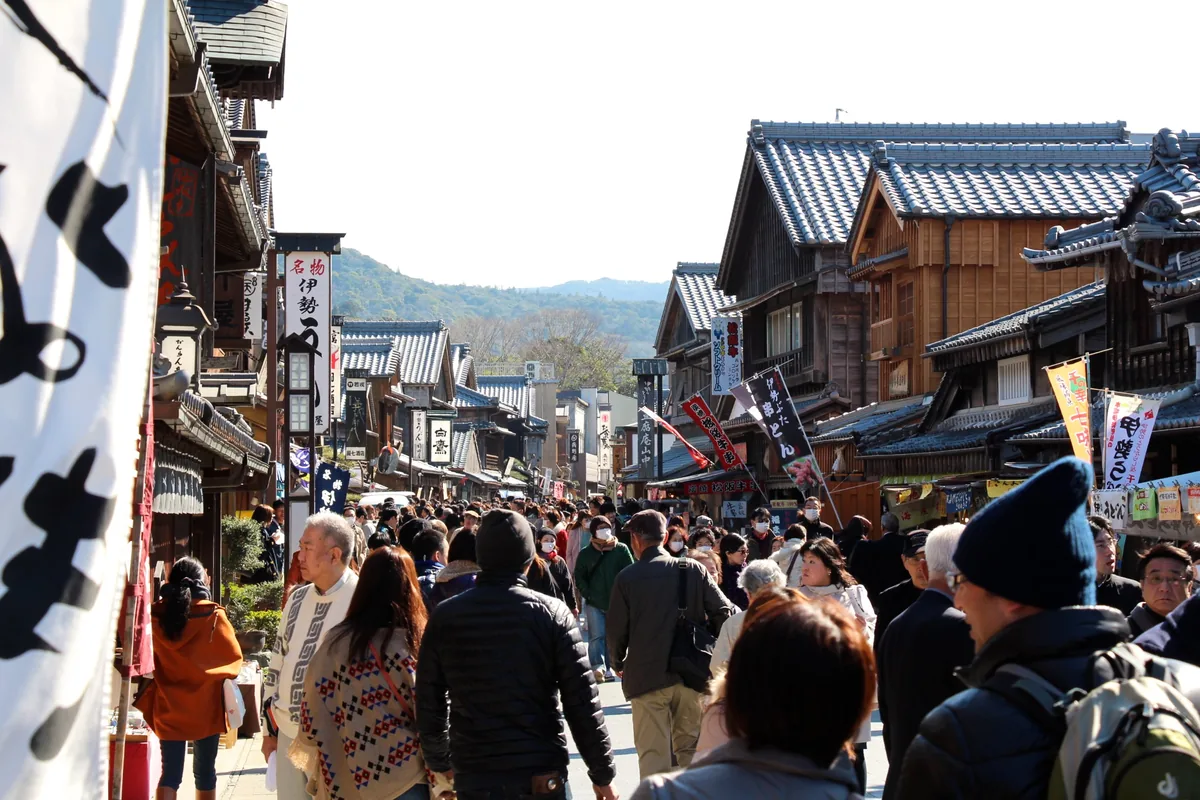 Wooden Edo-style buildings and crowds of visitors on Okage Yokocho
